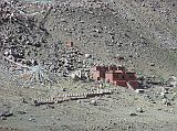 Tibet Kailash 08 Kora 24 Dirapuk Gompa Dirapuk Gompa (4890m) shines in a brief sunny period among the rain and hail. The Gompa takes its name from the words dira (meaning �female-yak-horn�) and puk (cave). The great monk G�tsangpa meditated her, supposedly from 1213 to 1217, and Buddhists say he first discovered the kora route around Kailash. He was led to Dirapuk by a yak that turned out to be the lion-faced-goddess Dakini (Khadroma), who guards the Khando Sanglam La. Just below the Gompa, another ashram is being built by Pujya Swami Chidanand Saraswatiji of the India Heritage Research Foundation.